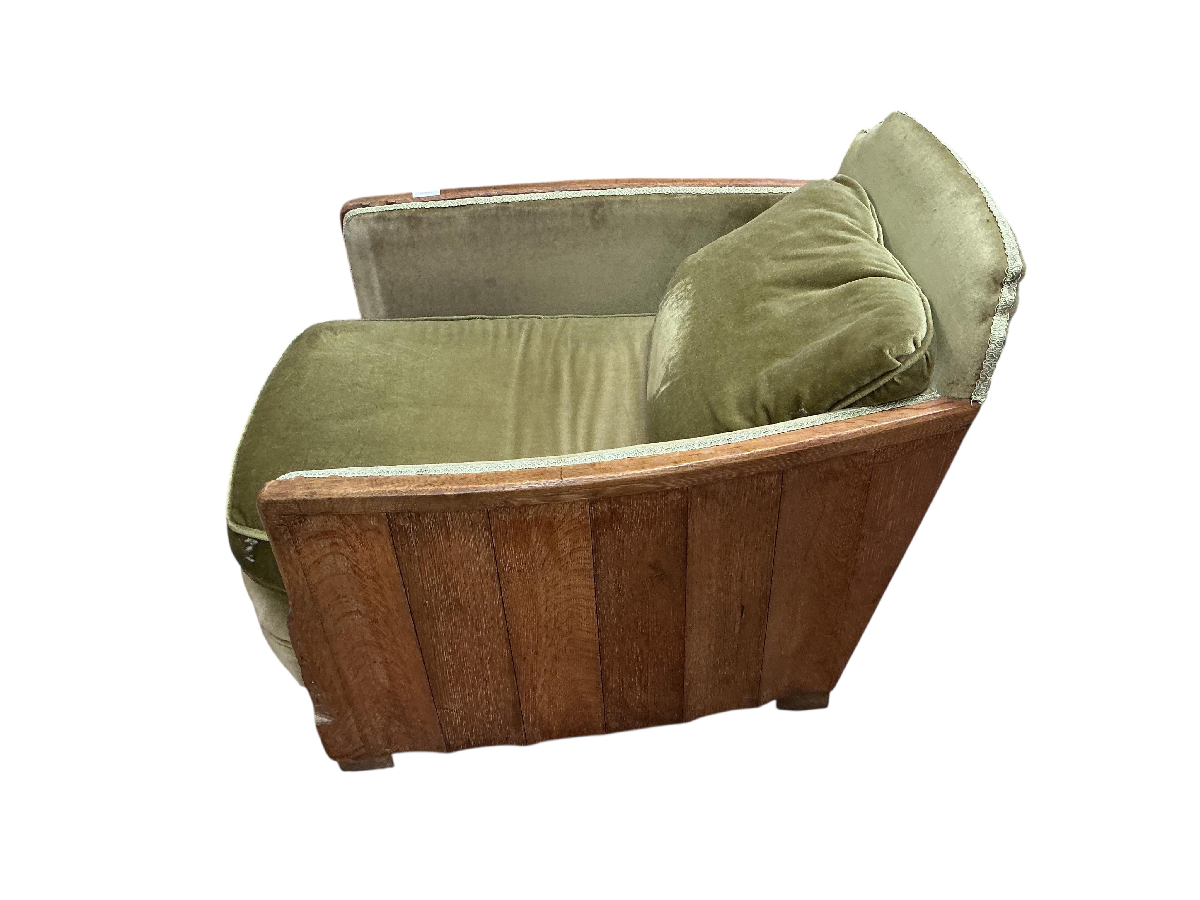 A pair of French Art Deco oak armchairs, width 69cm, depth 90cm, height 69cm